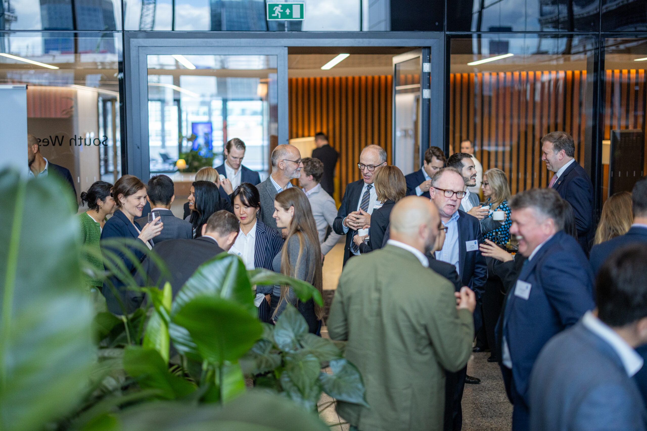 Attendees networking over coffee at UBS atrium
