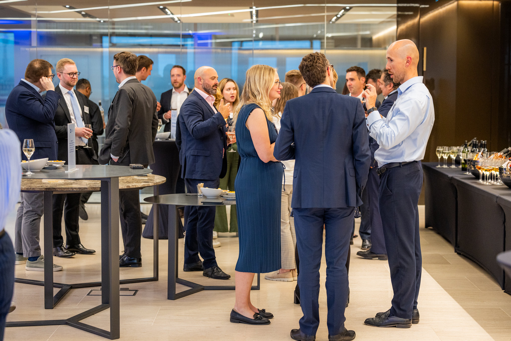 Attendees networking over drinks at DLA Piper's office